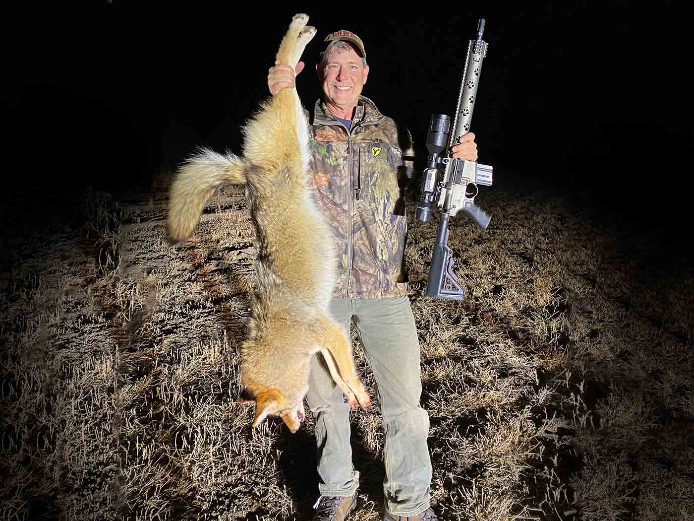 Fred Eichler holding coyote catch