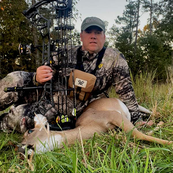 Man with his doe after hunting early season