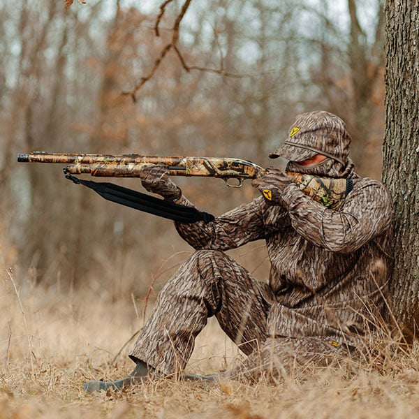 Man Fall Turkey Hunting wearing Silentec in Mossy Oak Bottomland Camo