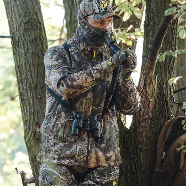 Man using a grunt call in a tree stand