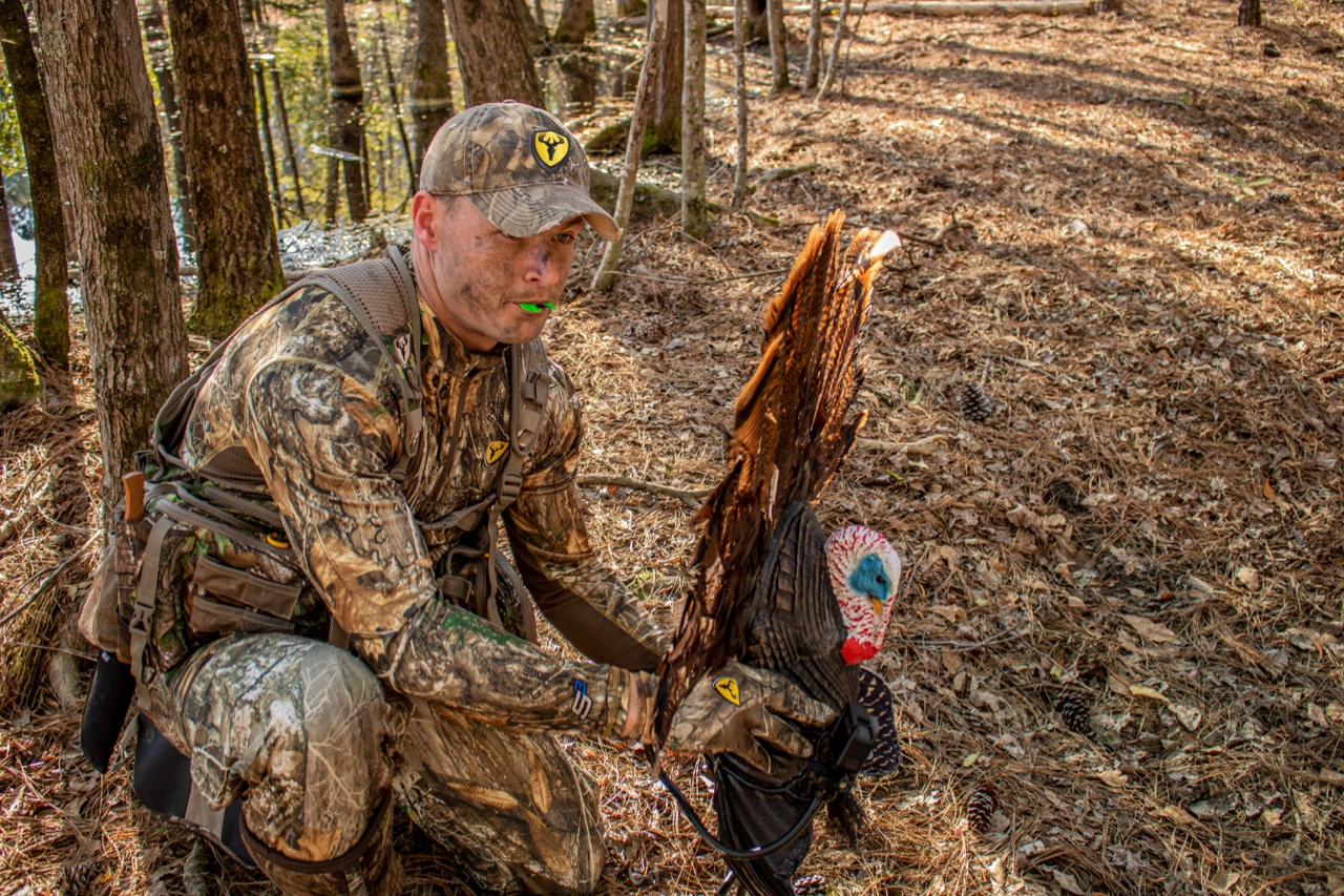 turkey hunter with turkey decoy and mouth call
